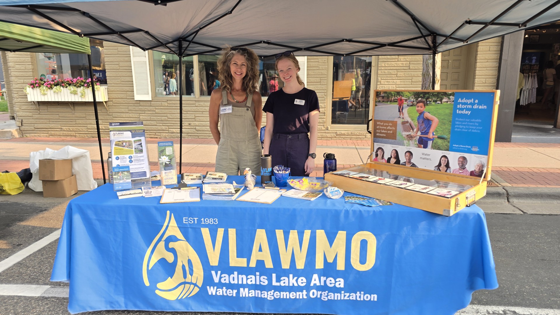 Watershed Award winner stands with VLAWMO staff at VLAWMO's educational booth during the White Bear Lake Environmental Resources Expo